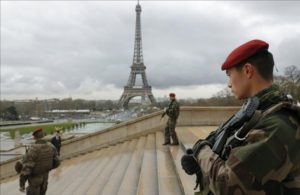 French army paratroopers patrol near the Eiffel tower in Paris